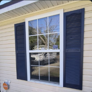 Window with new trim and shutters