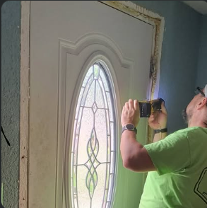 Entry door being fitted during installation