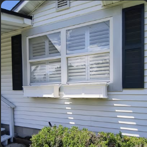 New shutters and flower boxes on a white house