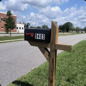 New mailbox mounted on a wooden post