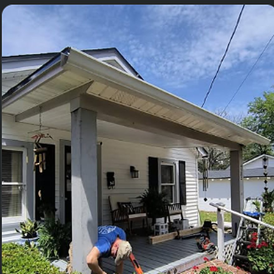 Crew member working on a front porch rebuild